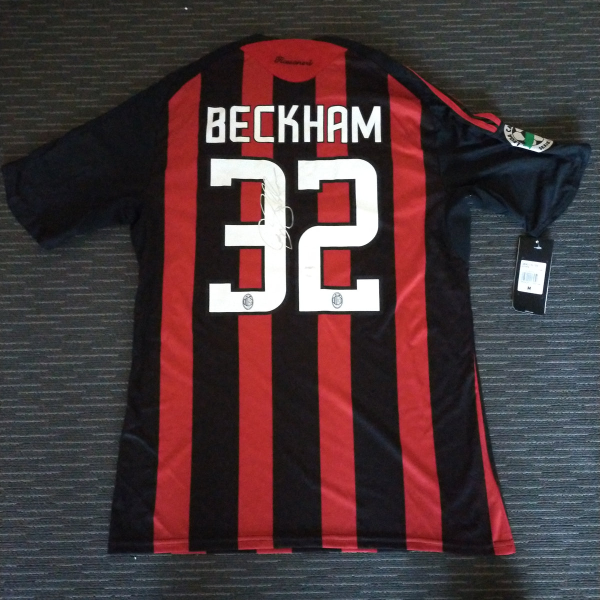 A framed and A.C. Milan football jersey signed by David Beckham